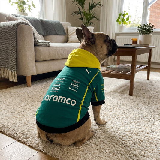 French bulldog wearing Aston Martin 2025 pet hoodie back view with aramco and Puma logos in living room